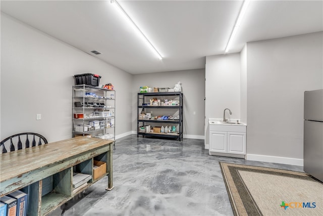 interior space featuring sink and stainless steel refrigerator