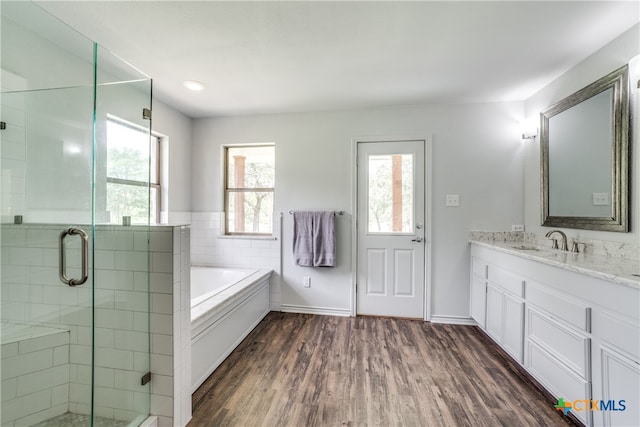 bathroom featuring hardwood / wood-style floors, a wealth of natural light, vanity, and plus walk in shower