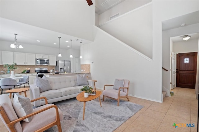2105 Town Centre Dr Unit 42, Round Rock, TX 78664 - living area featuring a towering ceiling, stairs, light tile patterned floors, a chandelier, and recessed lighting