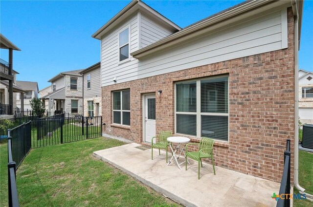 2105 Town Centre Dr Unit 42, Round Rock, TX 78664 - rear view of property featuring brick siding, a patio, and a residential view