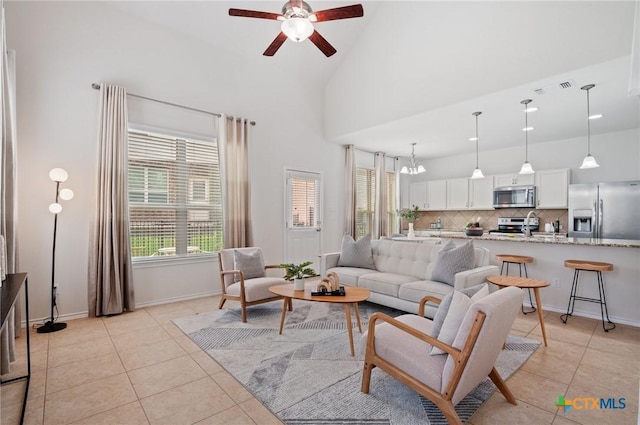 2105 Town Centre Dr Unit 42, Round Rock, TX 78664 - living area featuring a ceiling fan, light tile patterned floors, and high vaulted ceiling
