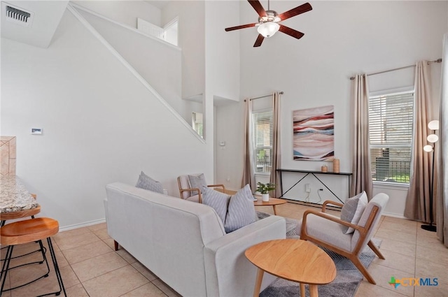 2105 Town Centre Dr Unit 42, Round Rock, TX 78664 - living room with a high ceiling, light tile patterned floors, and a ceiling fan
