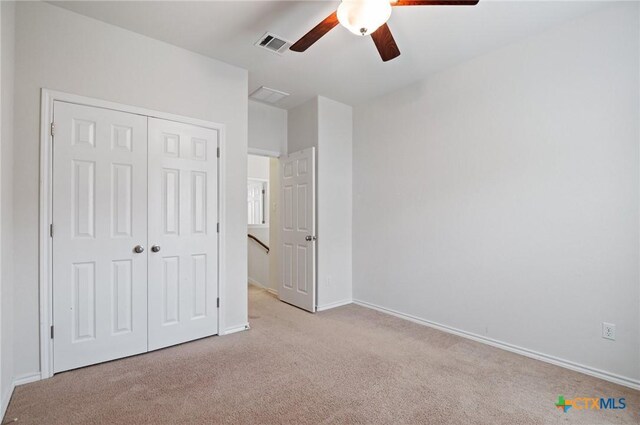 2105 Town Centre Dr Unit 42, Round Rock, TX 78664 - unfurnished bedroom with carpet, a closet, and a ceiling fan