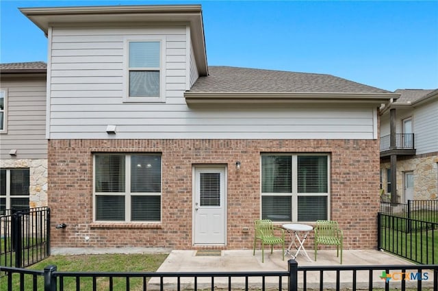 2105 Town Centre Dr Unit 42, Round Rock, TX 78664 - rear view of property featuring a patio, brick siding, and roof with shingles