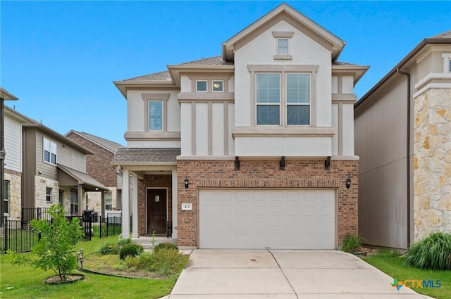 2105 Town Centre Dr Unit 42, Round Rock, TX 78664 - view of front of house with stucco siding, brick siding, concrete driveway, and a garage