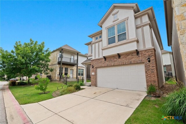2105 Town Centre Dr Unit 42, Round Rock, TX 78664 - view of front of home featuring brick siding, an attached garage, stucco siding, and driveway