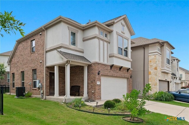 2105 Town Centre Dr Unit 42, Round Rock, TX 78664 - view of front of house featuring an attached garage, stucco siding, and a front yard