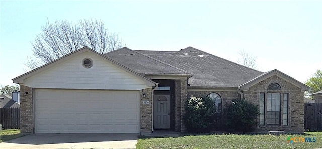 ranch-style home featuring concrete driveway, brick siding, and an attached garage