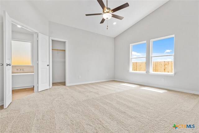 unfurnished bedroom with high vaulted ceiling, light colored carpet, and ceiling fan