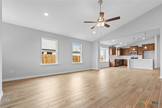 unfurnished living room with ceiling fan, light hardwood / wood-style flooring, and high vaulted ceiling