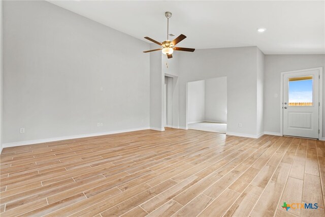 unfurnished living room featuring ceiling fan, light hardwood / wood-style flooring, and lofted ceiling