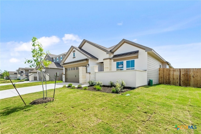 view of front of house featuring a garage and a front yard