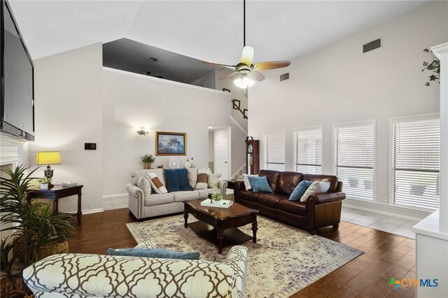 106 Westbrook Dr, Victoria, TX 77904 - living area featuring high vaulted ceiling, a ceiling fan, wood finished floors, stairway, and a fireplace