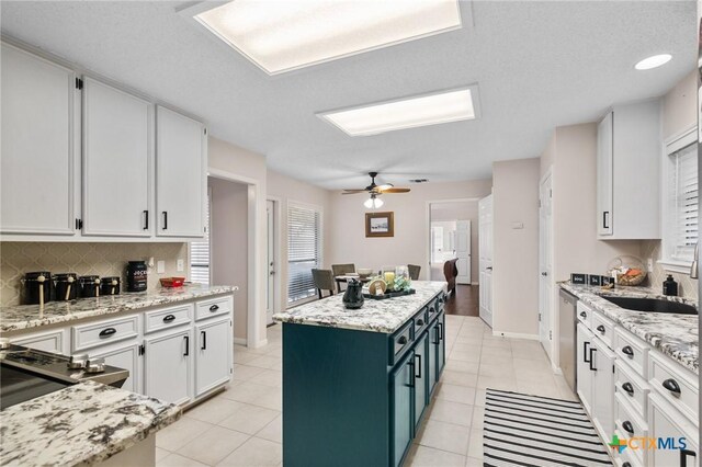 106 Westbrook Dr, Victoria, TX 77904 - kitchen with white cabinets, a kitchen island, stainless steel dishwasher, and tasteful backsplash