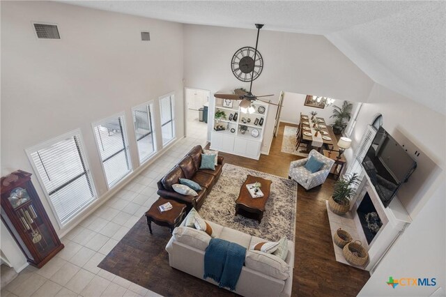 106 Westbrook Dr, Victoria, TX 77904 - living area with a textured ceiling, tile patterned flooring, a ceiling fan, and high vaulted ceiling