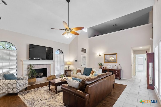106 Westbrook Dr, Victoria, TX 77904 - living area featuring a ceiling fan, high vaulted ceiling, a tiled fireplace, and light tile patterned floors