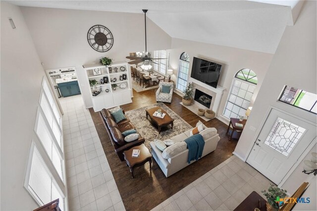106 Westbrook Dr, Victoria, TX 77904 - tiled living area featuring high vaulted ceiling, ceiling fan, and a fireplace