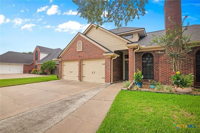 106 Westbrook Dr, Victoria, TX 77904 - traditional-style house with brick siding, concrete driveway, an attached garage, and a front yard