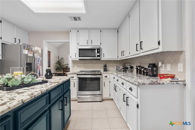 106 Westbrook Dr, Victoria, TX 77904 - kitchen with stainless steel appliances, white cabinets, and backsplash