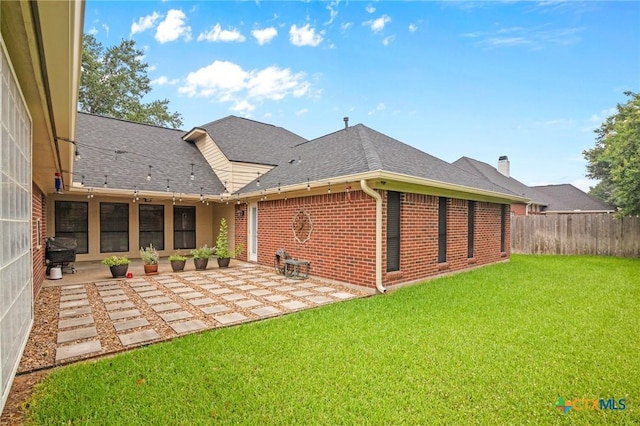 106 Westbrook Dr, Victoria, TX 77904 - rear view of house with a patio, brick siding, and a shingled roof