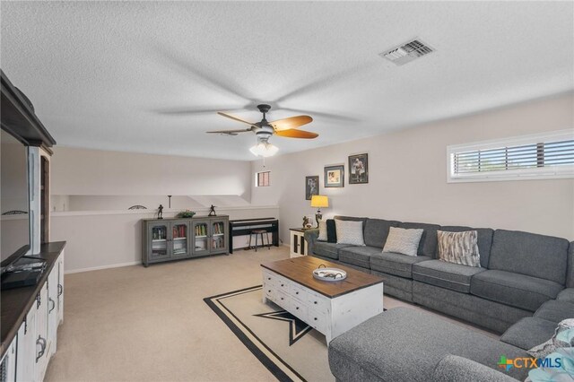 106 Westbrook Dr, Victoria, TX 77904 - living room featuring a ceiling fan, light carpet, and a textured ceiling