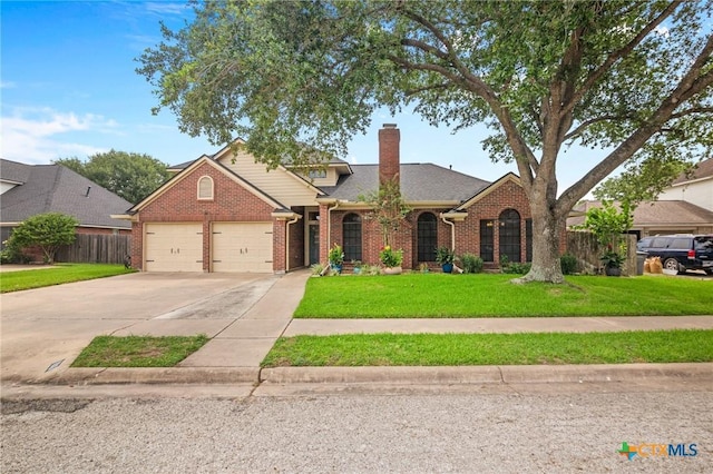 106 Westbrook Dr, Victoria, TX 77904 - traditional-style house with brick siding, a garage, driveway, and a chimney