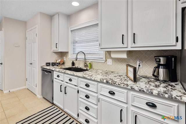 106 Westbrook Dr, Victoria, TX 77904 - kitchen featuring dishwasher, white cabinetry, tasteful backsplash, and light stone counters