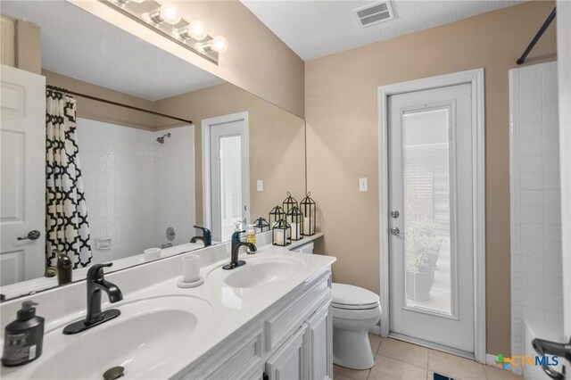 106 Westbrook Dr, Victoria, TX 77904 - bathroom with tile patterned flooring, a shower with curtain, and double vanity