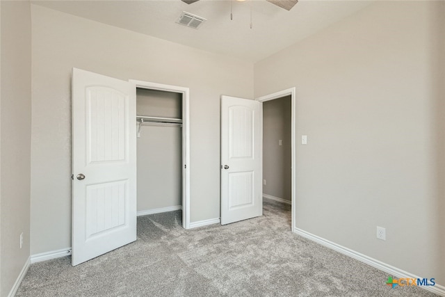 unfurnished bedroom with ceiling fan, light colored carpet, and a closet