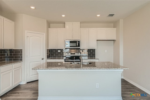 kitchen featuring white cabinetry, a kitchen island with sink, and appliances with stainless steel finishes