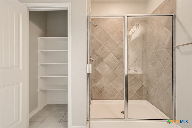 bathroom featuring tile patterned flooring and an enclosed shower