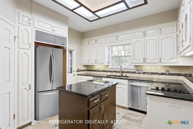 kitchen with white cabinetry, sink, a center island, and stainless steel appliances