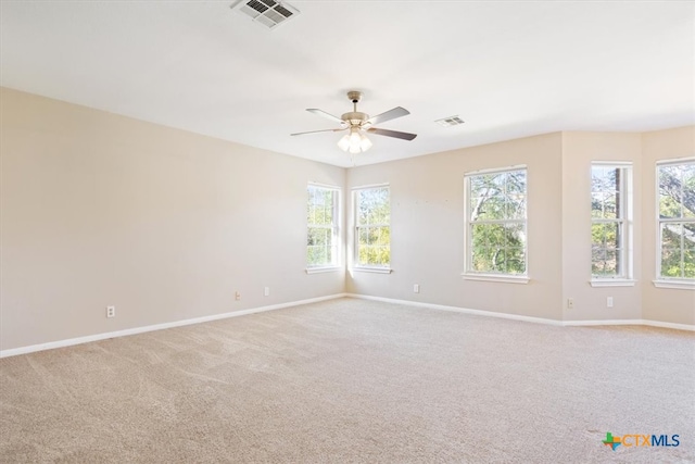 empty room with ceiling fan and light colored carpet