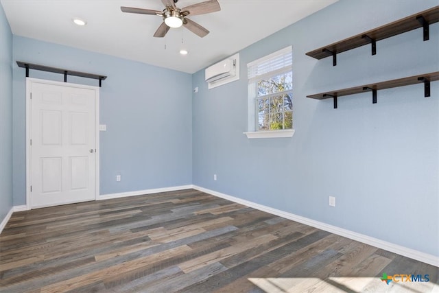 empty room featuring ceiling fan, an AC wall unit, and dark wood-type flooring