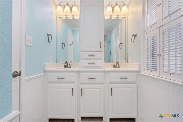 bathroom with vanity and ornamental molding