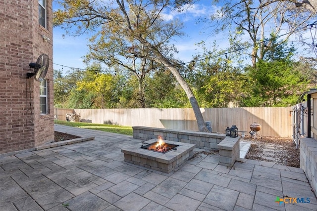 view of patio / terrace featuring an outdoor fire pit