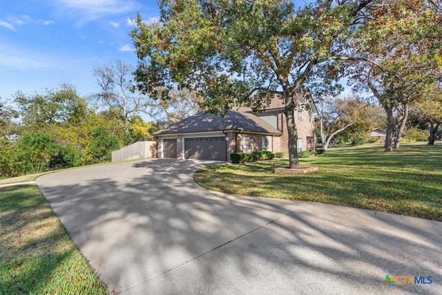 view of front facade with a garage and a front lawn