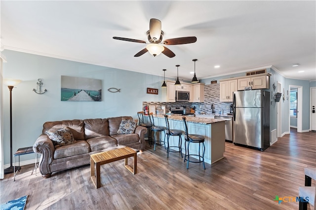 living room featuring ceiling fan, dark hardwood / wood-style flooring, and ornamental molding