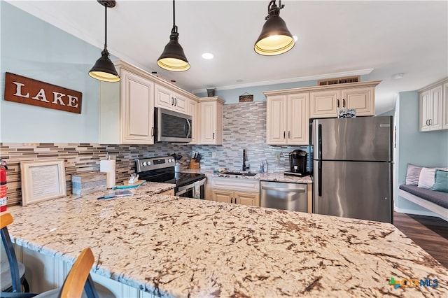 kitchen featuring stainless steel appliances, a breakfast bar, dark hardwood / wood-style floors, hanging light fixtures, and cream cabinetry