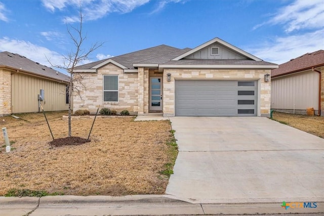 single story home with a garage, concrete driveway, stone siding, and board and batten siding