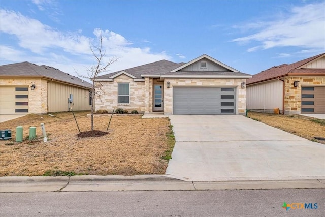 view of front of home with stone siding, concrete driveway, and an attached garage