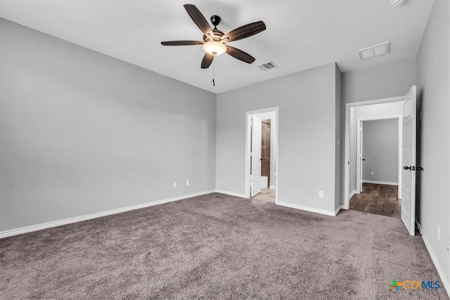 unfurnished bedroom featuring carpet, visible vents, and baseboards