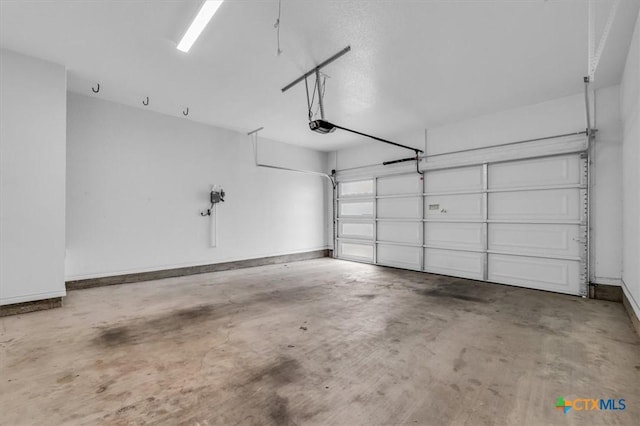 garage with a garage door opener and baseboards