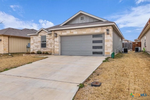 single story home featuring a garage, concrete driveway, central AC unit, and board and batten siding