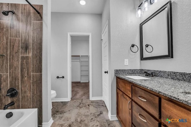 full bath featuring a walk in closet, shower / bathtub combination, double vanity, toilet, and a sink