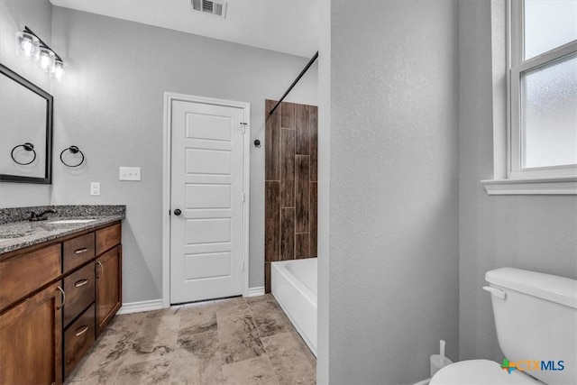 full bathroom with baseboards, visible vents, toilet, tub / shower combination, and vanity