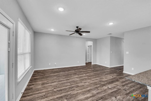 spare room featuring ceiling fan, baseboards, dark wood finished floors, and recessed lighting