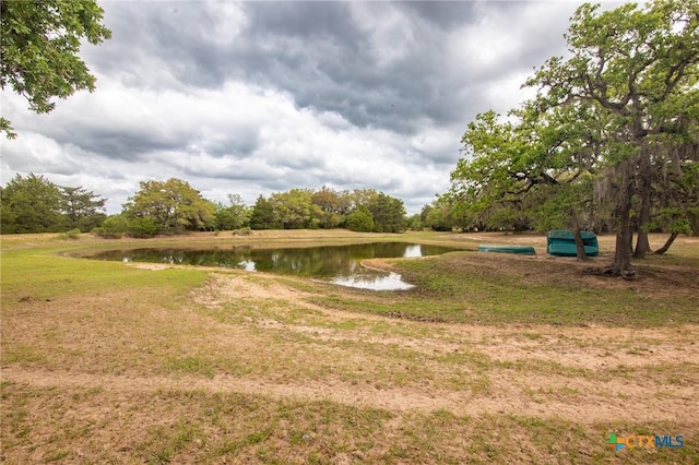 view of home's community with a lawn and a water view