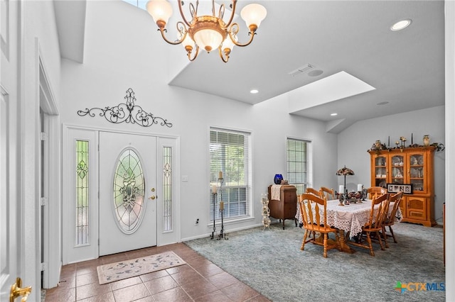 tiled foyer entrance with recessed lighting, visible vents, carpet flooring, and a notable chandelier