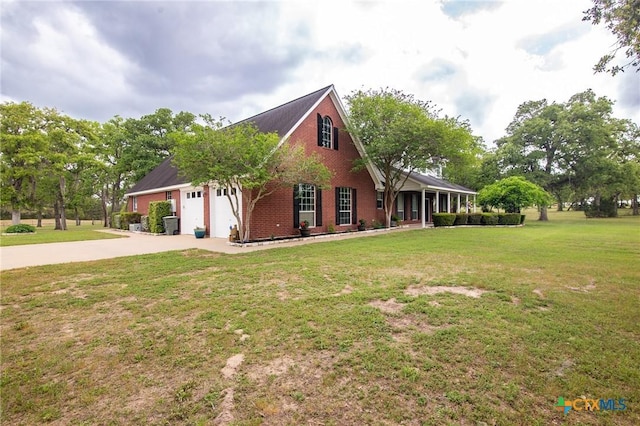 view of side of property featuring brick siding, a yard, an attached garage, and concrete driveway